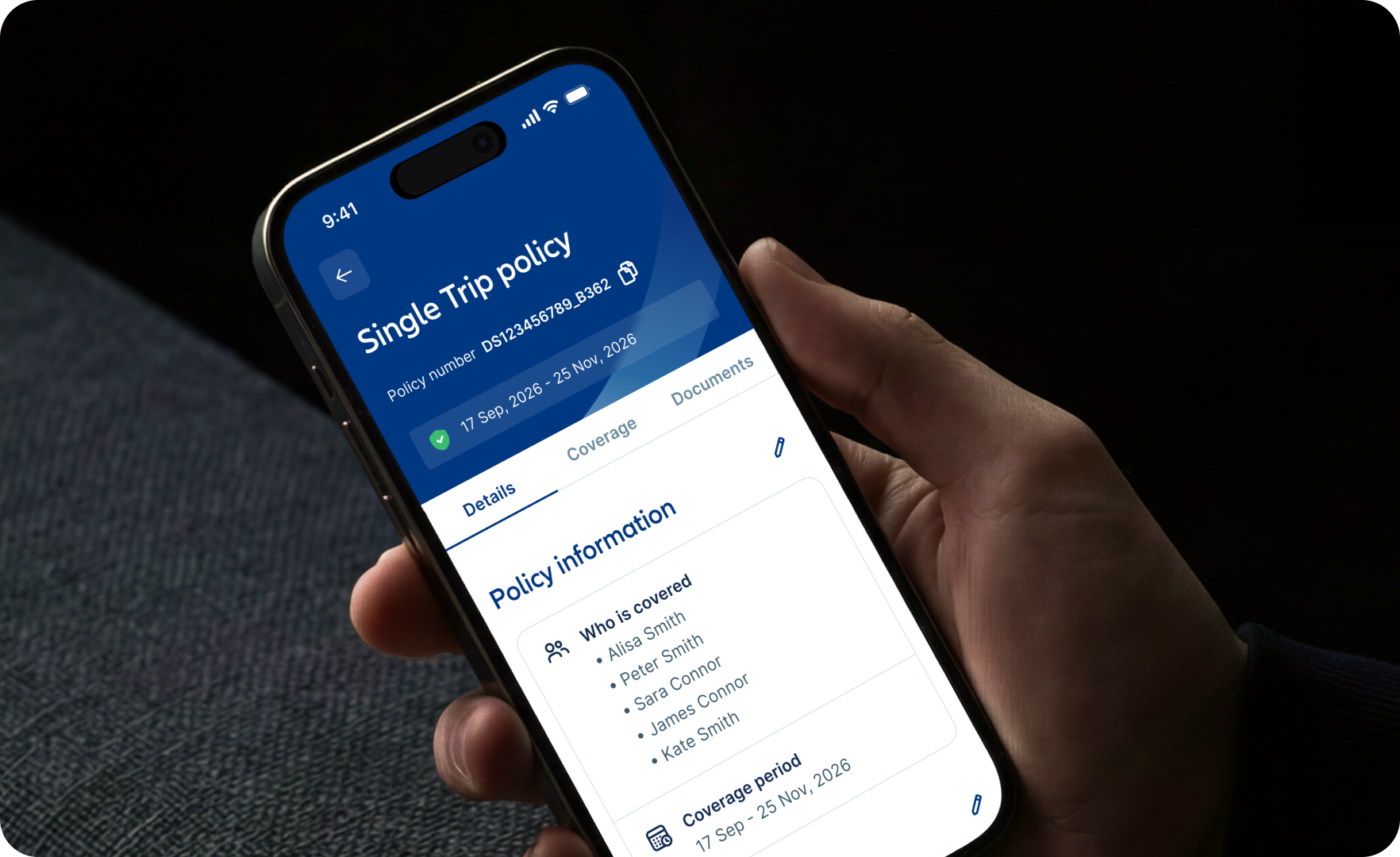 An image of a woman's hand holding a smartphone with the travel insurance policy details showing for Allianz insurance.